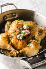 roasted chicken in a dutch oven with radishes and kale