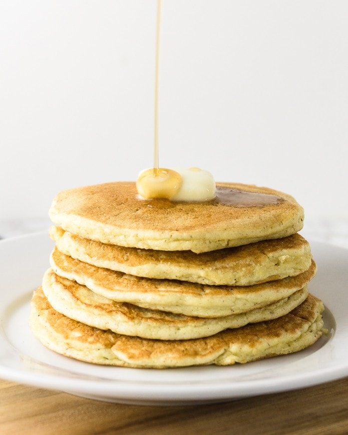 keto pancakes with keto syrup being poured on top