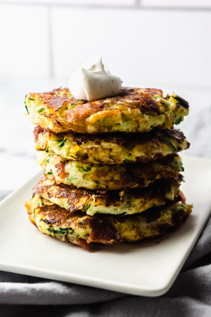 stack of crispy low carb zucchini fritters with bacon