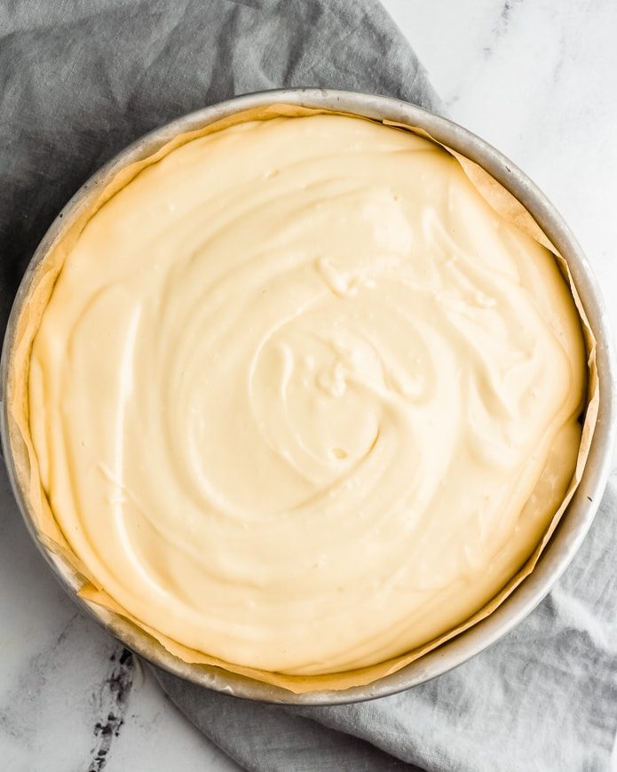 unbaked keto cheesecake batter in a low-carb crust