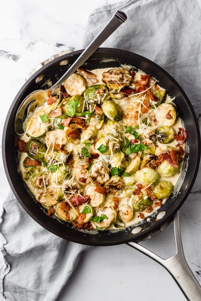 stovetop sauteed brussels sprouts in a creamy cheese sauce with bacon
