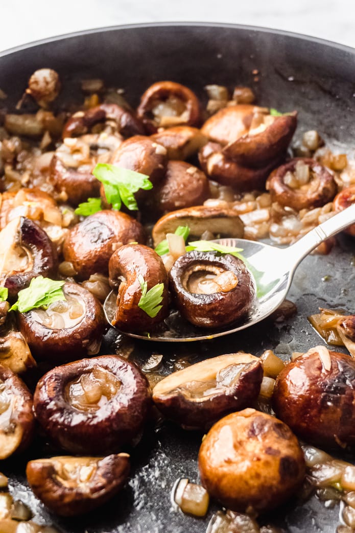 mushrooms in garlic butter sauce in a pan