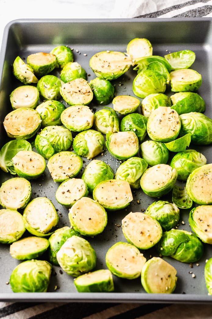 brussels sprouts on a sheet pan with salt and pepper